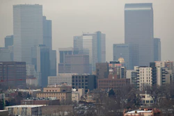 In this Jan. 21, 2003, file photograph, vehicles head inbound on South Broadway as polluted air obscures the view of the skyline of Denver from the south suburb of Englewood, Colo. The U.S. Environmental Protection Agency held a hearing Friday, Sept. 6, 2019, to discuss a plan to lower the ozone status of Denver and eight other northern Colorado counties from 'moderate' to 'serious,' a move that would force the state to clean the air but which businesses object to becuse of potential additional regulations.