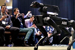 In this May 24, 2018, file photo, a Boston Dynamics SpotMini robot is walks through a conference room during a robotics summit in Boston. The Cirque du Soleil Entertainment Group says it’s in talks with robot-maker Boston Dynamics about using the four-legged Spot robot in its live shows.
