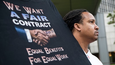 Sean Crawford, of United Auto Workers 598, rallies outside the Marriott Renaissance Hotel while the UAW GM Council holds a meeting inside the hotel in Detroit, Sunday Sept. 15, 2019. The United Auto Workers union announced that tens of thousands of its members at General Motors plants in the U.S. will go on strike Sunday night because contract negotiations with the automaker had broken down.