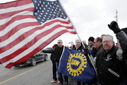 Mark Franko, 28-year General Motors employee, holds an American flag as employees gather outside the plant, Wednesday, March 6, 2019, in Lordstown, Ohio.