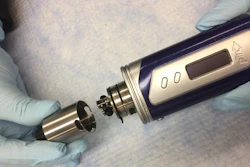 Photo of a typical tank-style electronic cigarette. With the lid off, the atomizer attached to the tank is revealed.