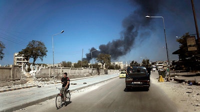 Smoke from government shelling in a residential area of Aleppo, Syria, Sept. 23, 2012.