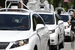 This May 13, 2014, file photo shows a row of self-driving Lexus cars at a Google event in Mountain View, Calif.