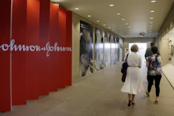 In this July 30, 2013, file photo, people walk along a corridor at the headquarters of Johnson & Johnson in New Brunswick, N.J.