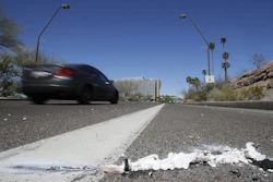 A vehicle goes by the scene of a fatality, where a pedestrian was stuck by an Uber vehicle in autonomous mode, in Tempe, Ariz., March 19, 2018.