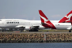 In this Aug. 20, 2015 file photo, two Qantas planes taxi on the runway at Sydney Airport.