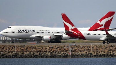 In this Aug. 20, 2015 file photo, two Qantas planes taxi on the runway at Sydney Airport.