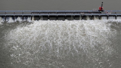 In this May 10, 2019, file photo, workers open bays of the Bonnet Carré Spillway in Norco, La.