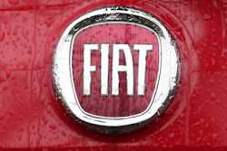 In this Jan. 2, 2014, file photo, a Fiat logo pictured on a car in Milan.