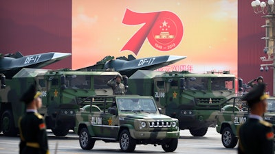 Chinese military vehicles carrying DF-17 ballistic missiles roll during a parade to commemorate the 70th anniversary of the founding of Communist China in Beijing, Oct. 1, 2019.