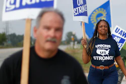 In this Monday, Sept. 30, 2019, photo, United Auto Workers members walk on the picket line during a strike at General Motors Orion Assembly plant in Orion Township, Mich.