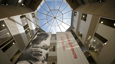 In this July 30, 2013, file photo, large banners hang in an atrium at the headquarters of Johnson & Johnson in New Brunswick, N.J.
