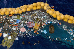 In this undated handout photo provided by The Ocean Clean Up, plastic is retained in front of an extended cork line in the Pacific Ocean. A Dutch inventor says that after a series of setbacks his system for catching plastic floating in the Pacific between California and Hawaii is now working. Boyan Slat, a university dropout who founded The Ocean Cleanup nonprofit, announced Wednesday, Oct. 2, 2019 that the floating boom is skimming up waste ranging in size from a discarded net and a car wheel complete with tire to chips of plastic measuring just 1 millimeter.