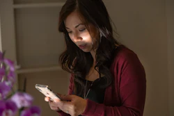 In this Aug. 28, 2019, photo, emergency room physician Dr. Anna Nguyen uses her smartphone to communicate with a remote patient from her Sacramento home.