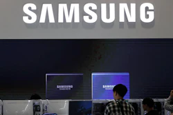 Visitors near the logo of Samsung Electronics at a semiconductor exhibition in Seoul, Oct. 8, 2019.
