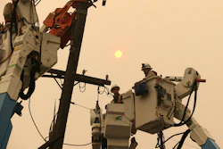 In this Nov. 9, 2018, file photo, Pacific Gas & Electric crews work to restore power lines in Paradise, Calif.