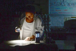 Carlos Lama of Bayside Cafe uses an LED lamp and light from his phone at the counter of the restaurant in Sausalito, Calif., Oct. 9, 2019.