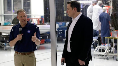NASA Administrator Jim Bridenstine, left, talks with SpaceX chief engineer Elon Musk at SpaceX headquarters in Hawthorne, Calif., Oct. 10, 2019.