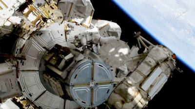 This image provided by NASA shows astronauts Andrew Morgan on a spacewalk outside the International Space Station on Friday, Oct. 11, 2019. Morgan and Christina Koch are replacing decade-old batteries in the station’s solar power network with new and improved lithium-ion versions. It’s the second of five spacewalks planned this month to install six new batteries that arrived via a Japanese supply ship two weeks ago.