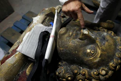 In this photo taken Oct. 9, 2019, stone expert Jean-Didier Mertz shows a broken nose of the golden angel that was once atop Notre Dame cathedral.