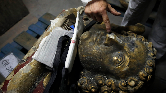 In this photo taken Oct. 9, 2019, stone expert Jean-Didier Mertz shows a broken nose of the golden angel that was once atop Notre Dame cathedral.