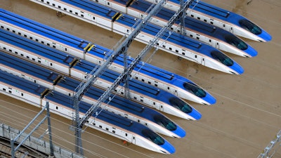 Bullet trains are seen submerged in muddy waters in Nagano, Japan, after Typhoon Hagibis hit the city, Sunday, Oct. 13, 2019.
