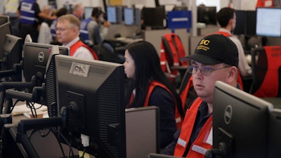 In this Oct. 10, 2019, file photo, Pacific Gas & Electric employees work in the PG&E Emergency Operations Center in San Francisco.