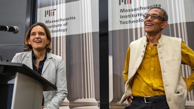 Esther Duflo, left, and Abhijit Banerjee speak during a news conference at Massachusetts Institute of Technology in Cambridge, Mass., Oct. 14, 2019.