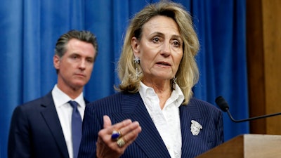 In this July 23, 2019, file photo, Marybel Batjer, of the California Public Utilities Commission, speaks during a news conference as Gov. Gavin Newsom looks on in Sacramento, Calif.