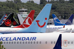 In this June 27, 2019, file photo, dozens of grounded Boeing 737 Max airplanes crowd a parking area adjacent to Boeing Field in Seattle.