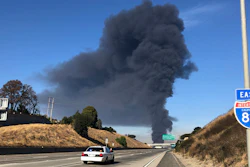Interstate 80 is closed as a fire at an oil storage facility burns in the background Tuesday, Oct. 15, 2019, in Rodeo, Calif.