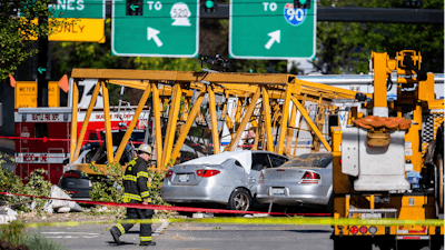In this April 27, 2019, file photo, emergency crews work the scene of a construction crane collapse near near Interstate 5 in Seattle.