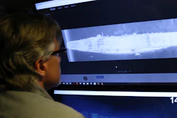 In this Oct. 16, 2019, photo, Vulcan Inc. director of subsea operations on the Petrel, Rob Kraft, looks at images of the Japanese aircraft carrier Kaga, off Midway Atoll in the Northwestern Hawaiian Islands.