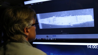 In this Oct. 16, 2019, photo, Vulcan Inc. director of subsea operations on the Petrel, Rob Kraft, looks at images of the Japanese aircraft carrier Kaga, off Midway Atoll in the Northwestern Hawaiian Islands.