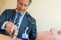 In this July 8, 2019 photo, James Thomas, a cardiologist at Northwestern Hospital in Chicago, examines Dennis Calling, a retired Chicago inspector.