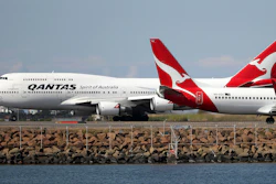 In this Aug. 20, 2015, file photo, two Qantas planes taxi on the runway at Sydney Airport.