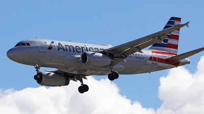 In this Oct. 18, 2019, photo, an American Airline plane flies in to Salt Lake City International Airport.