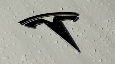 This Oct. 18, 2019, photo shows a Tesla logo in Salt Lake City.