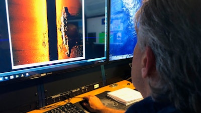 Rob Kraft, director of undersea operations at Vulcan Inc., reviews sonar scans of a warship found by the crew of the research vessel Petrel, Sunday, Oct. 20, 2019.