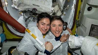 In this photo released by NASA on Friday, Oct. 18, 2019, U.S. astronauts Jessica Meir, left, and Christina Koch pose for a photo in the International Space Station.