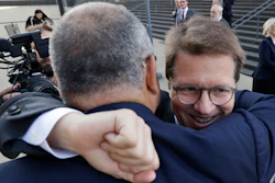 Attorney Mark Lanier gets a hug outside the U.S. Federal courthouse, Oct. 21, 2019, in Cleveland.