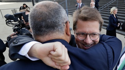 Attorney Mark Lanier gets a hug outside the U.S. Federal courthouse, Oct. 21, 2019, in Cleveland.