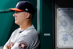 In this June 17, 2019, file photo, Houston Astros manager AJ Hinch looks on from the dugout in the fifth inning of a baseball game against the Reds in Cincinnati.