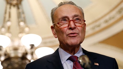 In this Oct. 22, 2019, photo, Senate Minority Leader Sen. Chuck Schumer of N.Y., speaks to members of the media following a Senate policy luncheon on Capitol Hill in Washington. Schumer is moving Democrats’ climate talk to where the rubber meets the road, proposing a $462 billion trade-in program to get millions of Americans out of climate-damaging gas vehicles and into electric or hybrid cars over the next decade.