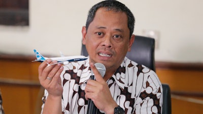 National Transportation Safety Committee investigator Nurcahyo Utomo holds a model of an airplane during a press conference in Jakarta, Oct. 25, 2019.