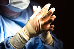 In this June 28, 2016 file photo, a doctor prepares for a surgical procedure at a hospital in Washington.