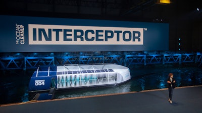 Young Dutch inventor Boyan Slat, right, unveils the Interceptor in Rotterdam, Netherlands, Saturday, Oct. 26, 2019. Slat is taking his effort to clean up floating plastic from the Pacific Ocean to rivers, using the Interceptor, a new floating device to catch garbage before it reaches the seas.