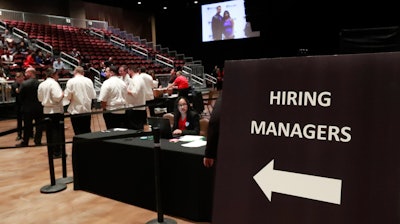 In this June 4, 2019, file photo, managers wait for job applicants at the Seminole Hard Rock Hotel & Casino Hollywood during a job fair in Hollywood, Fla.