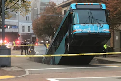 Authorities investigate after a Port Authority bus was caught in a sinkhole in downtown Pittsburgh on Monday, Oct. 28, 2019. The Port Authority of Allegheny County says the lone passenger is being treated Monday morning for minor injuries.