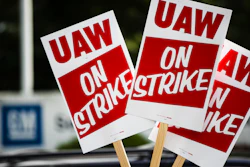 In this Sept. 16, 2019, file photo, signs are posted during a demonstration outside a General Motors facility in Langhorne, Pa.